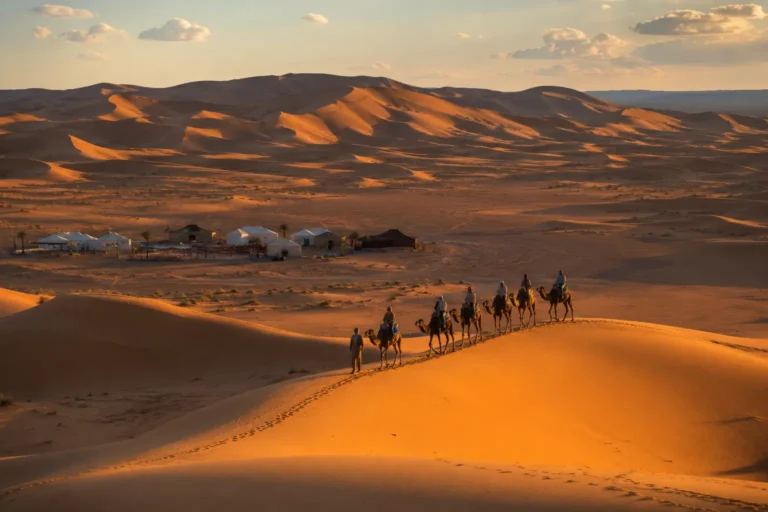 Camel caravan and desert camp in Merzouga dunes
