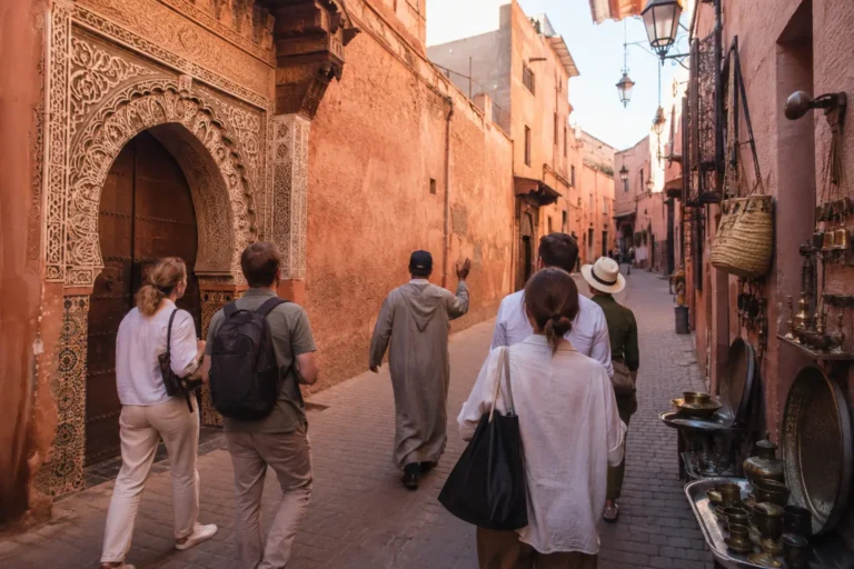 Guide leading visitors through a historic Marrakech Medina street
